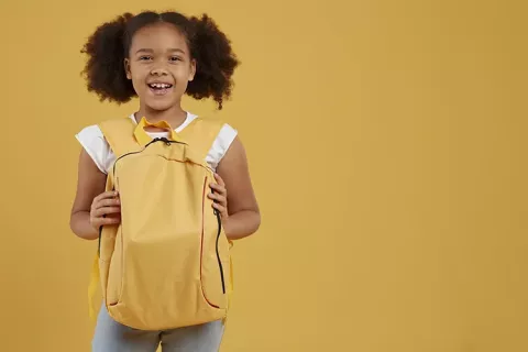 Niña con maleta escolar