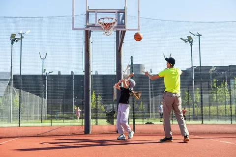 Adulto y niño jugando baloncesto