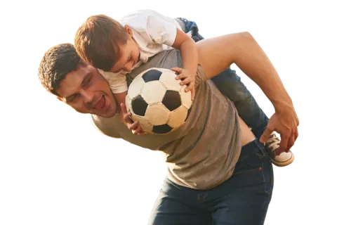 Papá e hijo jugando con balón de futbol