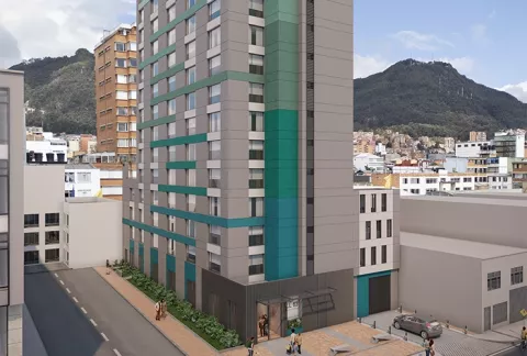 Fachada conjunto Karakalí Colsubsidio muestra una torre, edificios y personas, cerca a los cerros.