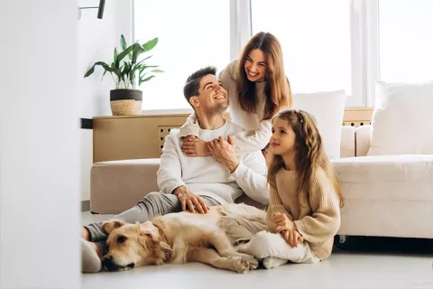 Familia sentada en la sala de su nueva vivienda