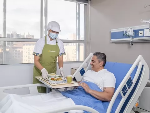 Paciente recibiendo su almuerzo en el hospital