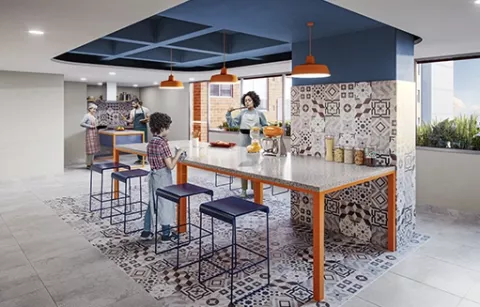 En el club cocina del conjunto Eskala hay ina familia preparando unas onces.