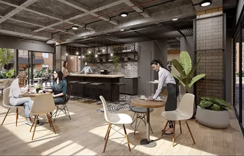Coworking y cafetería de Pacifika muestra personas conversando, sillas y mesero.