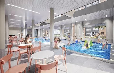 Piscina para niños del conjunto Zefiro muestra mesas y familia en este espacio.