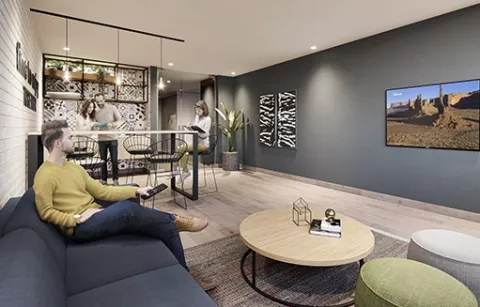 Sala premium del conjunto Zefari muestra a persona viendo televisión.