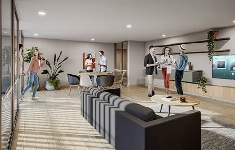 La sala VIP del conjunto Eskala muestra a personas conversando, decorado con plantas y sofá.
