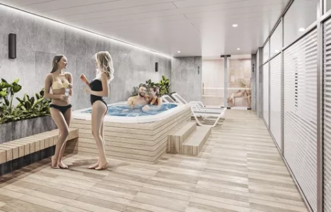 El spa del conjunto Eskala muestra a mujeres conversando cerca al jacuzzi.
