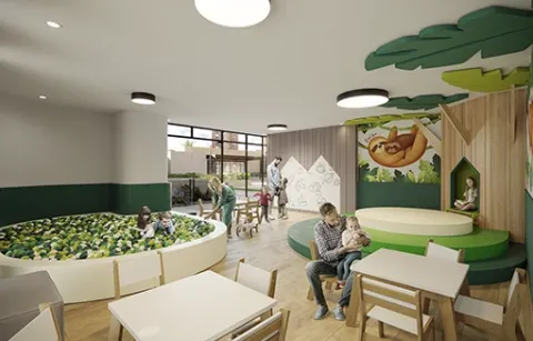 Salón infantil de Centriko muestra a padre con su hijo y una piscina de pelotas.