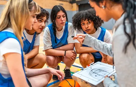 Mujeres entrenan y compiten en un torneo basquetbol empresarial.