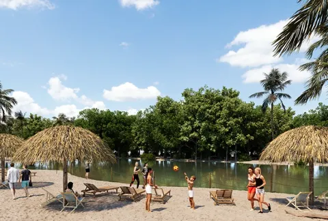 Lago de Club Playa muestra parasoles, zonas verdes y personas tomando sol