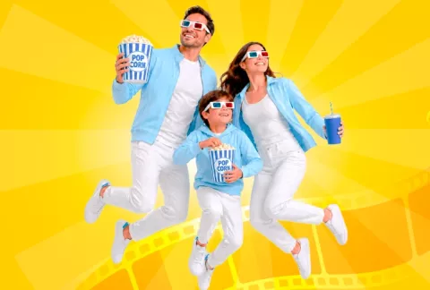Familia sonriendo durante una función de cine.