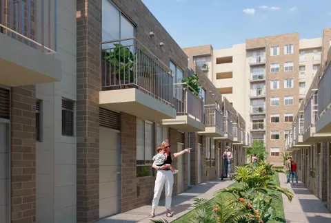 Exterior de las casas Palma Real, muestra la fachada de las viviendas de dos pisos.