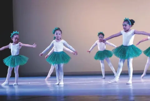 Seis jóvenes bailarinas con tutús y diademas verdes practicando ballet en Teatro Colsubsidio.